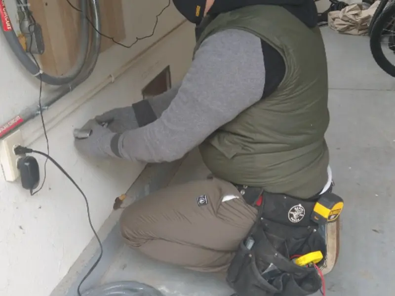Electrician performing outlet wiring in a Davenport garage